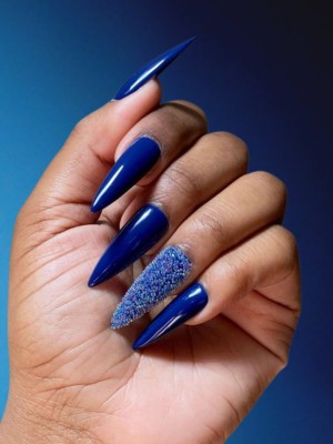 Dark blue nails with glittery accents